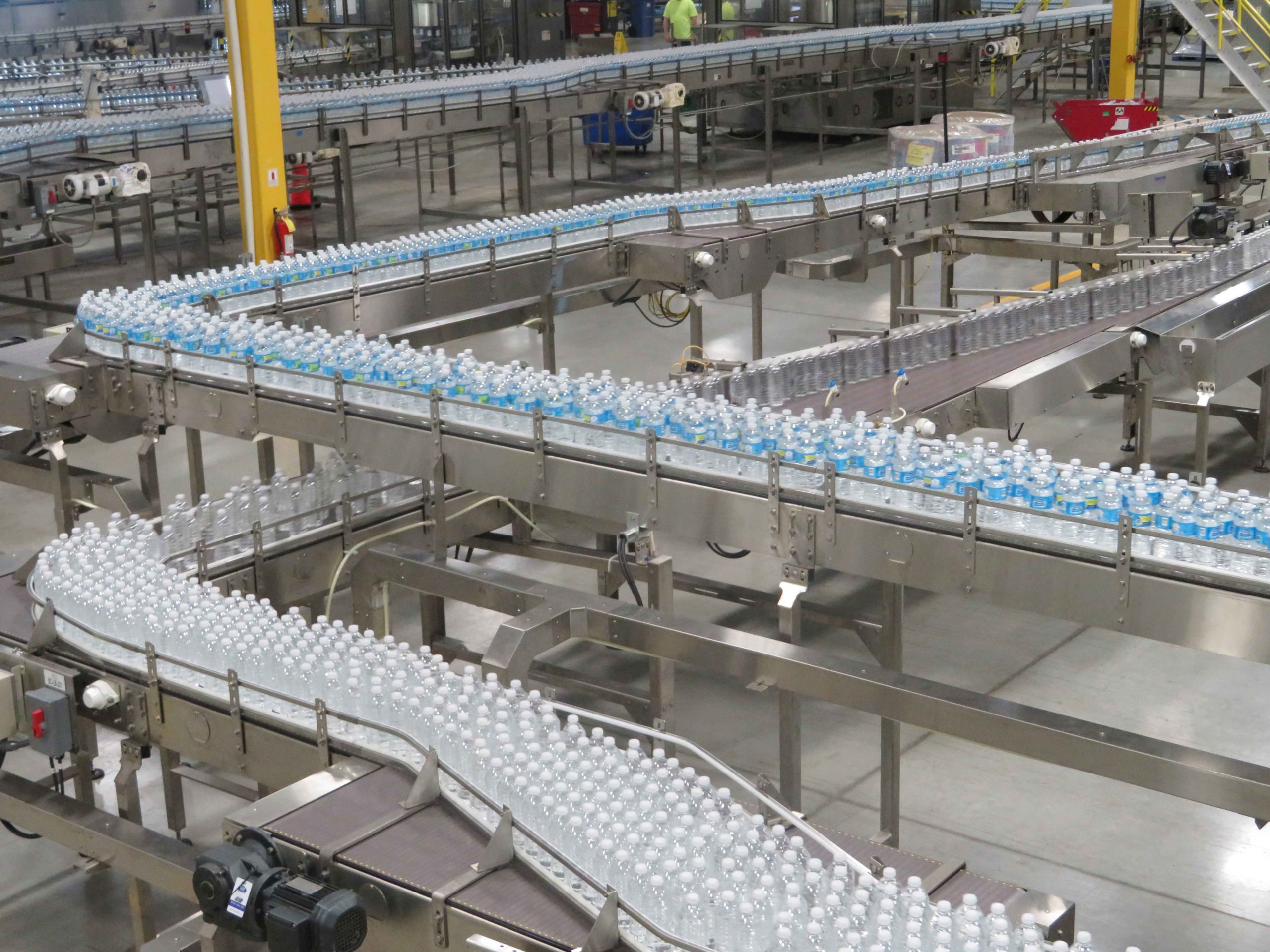 High-Speed PET Water Line: High angle shot of the nestle water bottles shuffling down the line